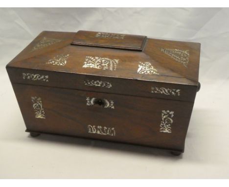 A 19th century rosewood rectangular sarcophagus-shaped tea caddy inlaid with mother of pearl floral designs, the interior wit