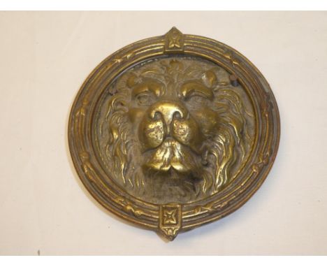 A large brass lion's mask door knocker with hinged circular surround, 8½"  diameter
