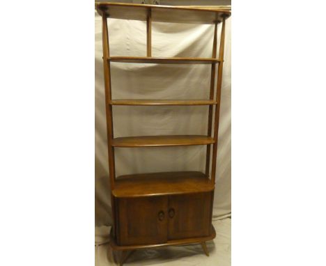 A 1960's Ercol light elm room divider/bookcase with adjustable open shelves above a cupboard enclosed by two panelled doors, 
