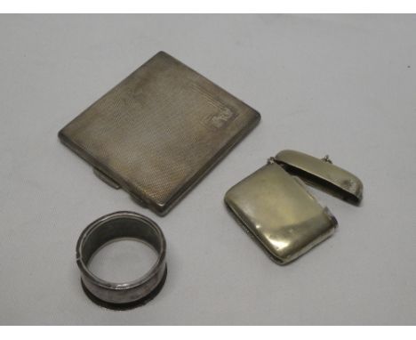 A silver rectangular cigarette case with engine-turned decoration, two various silver napkin rings, silver plated vesta case,