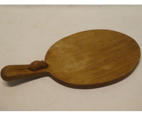 An unusual carved oak cheeseboard by Robert Thompson with "Mouseman" decorated handle 15" long