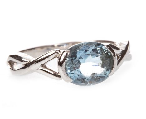 BLUE GEM SET RING, the oval blue gem 8mm long, on twist shoulders, in eighteen carat white gold, size T, 6.1g