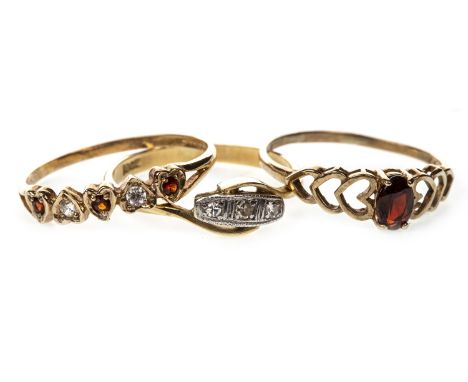 THREE GOLD RINGS, comprising an early twentieth century diamond ring, marked 18Ct, size Q, 2.4g; a red gem set ring and a red
