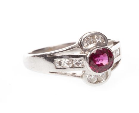 RUBY AND DIAMOND RING, the openwork bezel set with an oval ruby flanked by round brilliant cut diamonds, the diamonds totalli