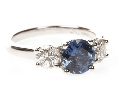 SAPPHIRE AND DIAMOND THREE STONE RING, the round faceted sapphire flanked by two round brilliant cut diamonds approximately 0