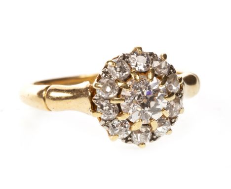 DIAMOND CLUSTER RING, the central old cut diamond of approximately 0.80 carats, within a halo of smaller old cut diamonds tot