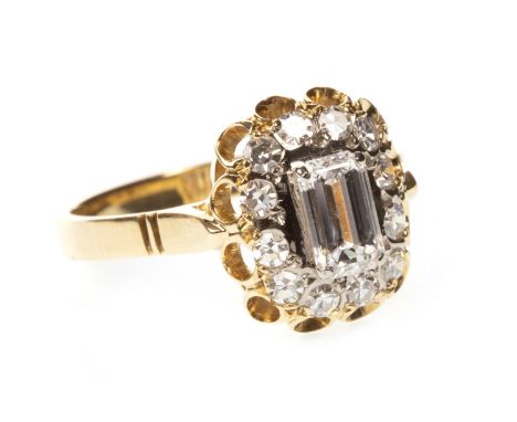 DIAMOND CLUSTER RING, the emerald cut diamond of approximately 0.72 carats within a halo of single cut diamonds totalling a f