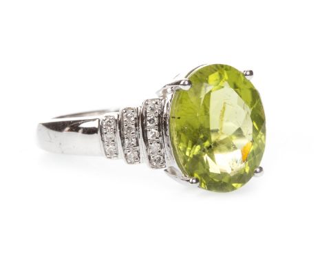 PERIDOT AND DIAMOND RING, the oval peridot of approximately 3.56 carats, with three diamond set sections to each shoulder, th