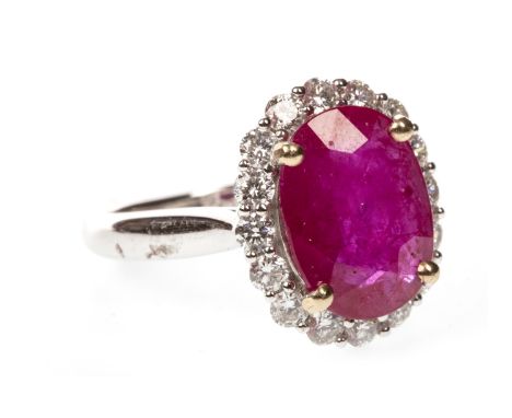 RUBY AND DIAMOND CLUSTER RING, the oval ruby 12x9mm, within a halo of round brilliant cut diamonds totalling approximately 0.