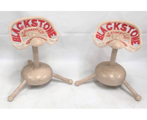 Pair of Blackstone &amp; Company Ltd Stamford cast iron tractor seats upon later pedestal stands, height 60cm.