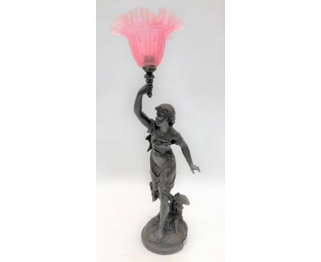 A bronzed spelter figural table lamp base after Brucnon 'L'Orage', modelled as a girl holding aloft a torch with pink frosted