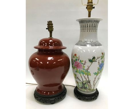 A 20th century Chinese famille rose porcelain table lamp base painted with rocks issuing flowers and with a pair of birds on 