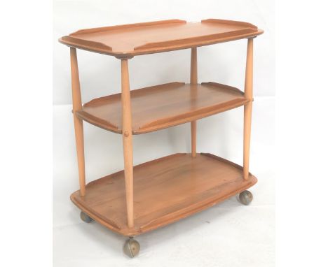 An Ercol pale elm three tier trolley with casters, width 71cm. 