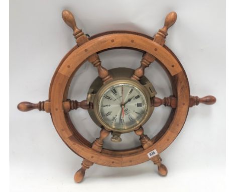 A modern ship's portal and wheel quartz wall clock by Plastimo, diameter overall 63cm