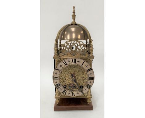 A brass lantern clock with later two-train movement, with silvered 6.25in chaptering with black Roman Numerals and with tulip