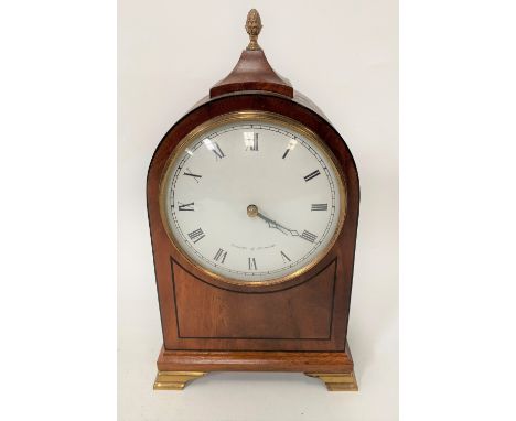 A mahogany cased timepiece with 4.5in white enamel dial with black Roman Numerals and signed Comitty of London, the arched ca