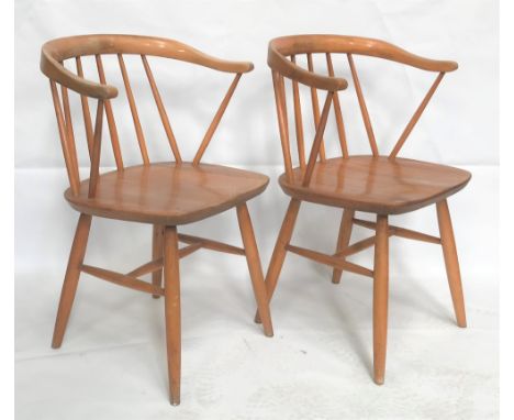 A pair of Ercol pale elm and beech carver chairs. 