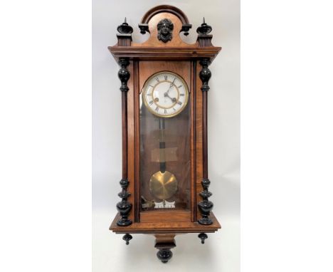 A Junghams two-train Vienna wall clock with walnut case, height including surmount 83cm