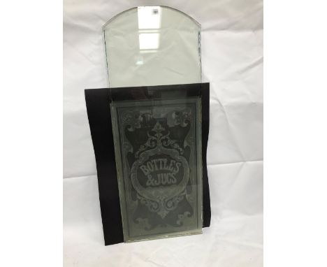 An early 20th century glass pub window panel with etched decoration and inscribed BOTTLES &amp; JUGS, height 117cm x width 44