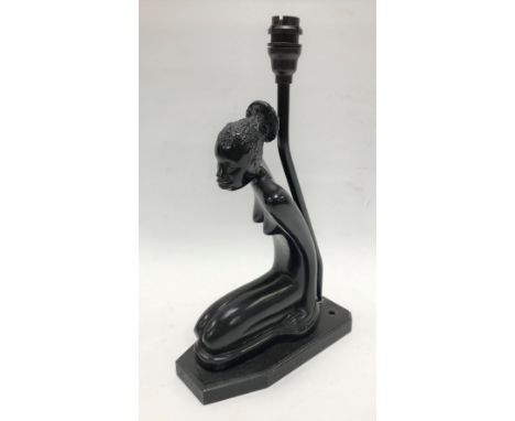 An Art Deco figural table lamp base in ebonised wood, depicting a kneeling African lady with bakelite fittings, height 7.5cm.