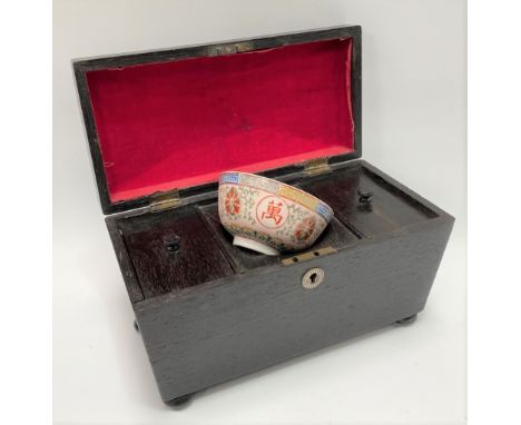 A George III ebony three section tea caddy of sarcophagus form raised on bun feet, width 30cm. 