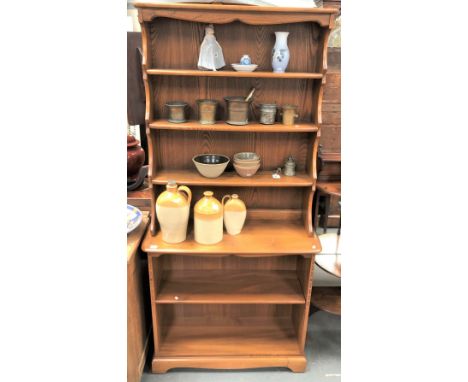 Pale elm Ercol two section dresser, the raised top with three fixed shelves, the base with an adjustable shelf, height 192cm 