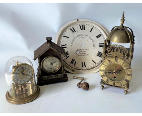 A small brass cased lantern type timepiece with quartz movement, 29cm; together with a small torsion timepiece by Elo, a smal