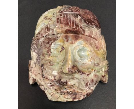 An ancient Mayan style carved red and grey marble mask, with old label to the back inscribed in pen 'Jamoncill - MEXIQUE 1920