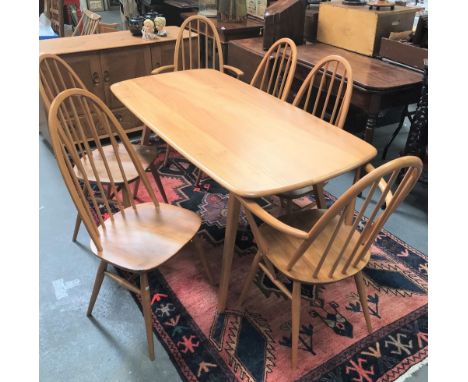 An Ercol blonde elm rectangular dining table with four splayed feet, 75 x 154cm, height 71cm, together with a set of six Quak