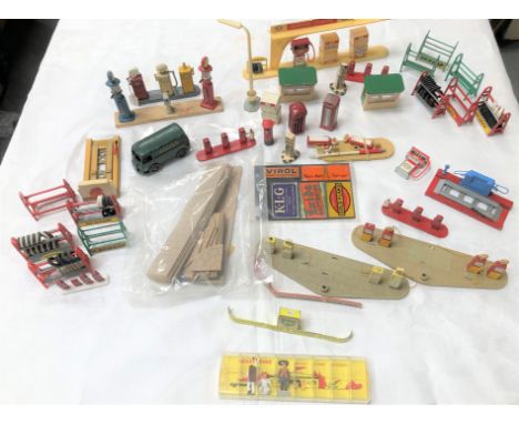 Collection of Dinky Toys petrol pump and garage parts, including Dunlop tyre stands, petrol pump stations, petrol pumps, a di