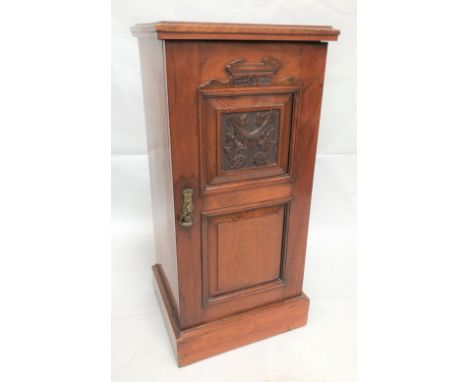 Edwardian walnut pot cupboard with carved fielded panel door, height 79cm.