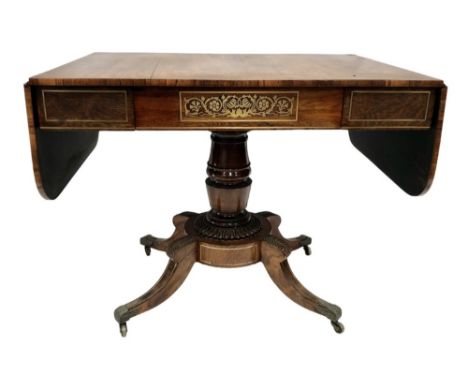 A good Regency rosewood brass inlaid pedestal sofa table, the top brass strung over the frieze, with single drawer and stylis