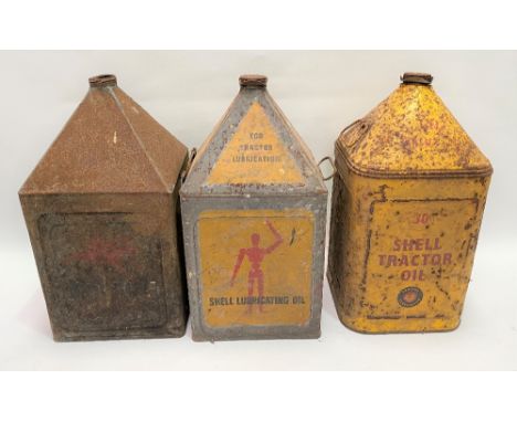 Three vintage tractor oil cans, two for Shell, the other for Moboil, each height 50cm.