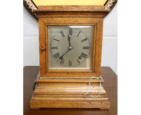 A German Oak Striking Mantel Clock, movement stamped W &amp; H, 30cm highThe case is slightly faded. Case with minor dents an