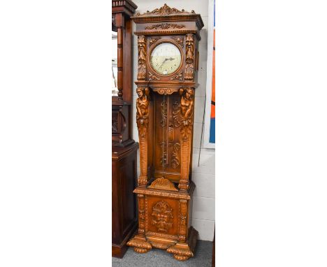 A Modern Quarter Striking Carved Longcase Clock, the case elaborately carved with masks and figural pilasters, triple weight 