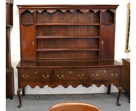 A George III Oak Dresser and Rack, 198cm by 50cm 200cmBrassware replaced. Upper section cupboards are locked and no key prese