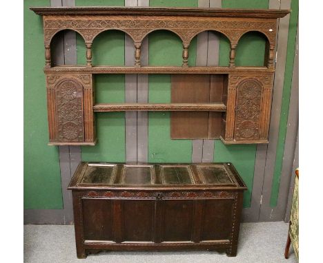 An 18th Century Oak Four Panel Coffer, with lunette carved decoration, 152cm by 60cm by 73cm, and A Carved Oak Wall Shelf (fo