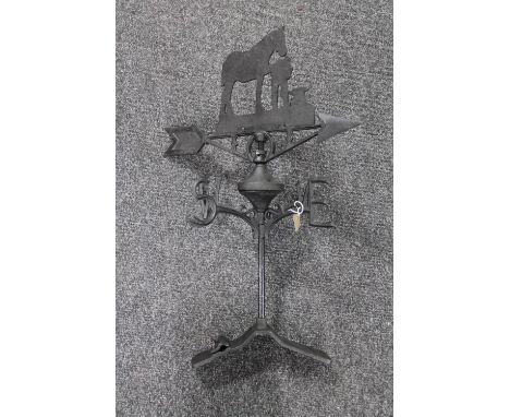 A cast iron farrier with horse weather vane