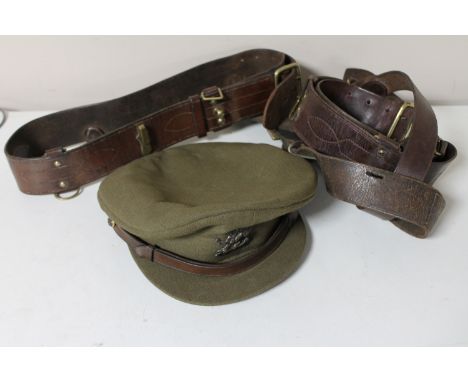 A basket containing a British army officer's cap together with three military leather belts 