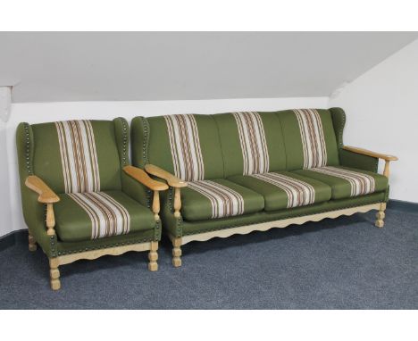 A blonde oak framed three seater settee and armchair in green striped fabric 