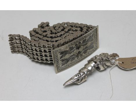A bespoke bike chain belt with buckle together with a metal finger ring 
