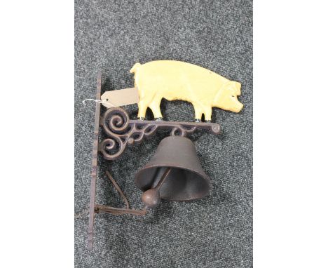 A cast iron pig wall bracket with bell