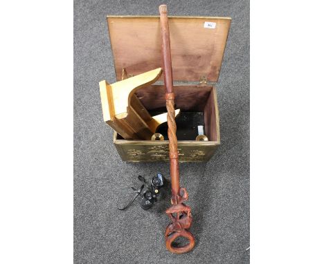 A brass embossed box containing a gilt wall shelf, tribal walking stick, brass candlesticks and a pair of Commodore binocular