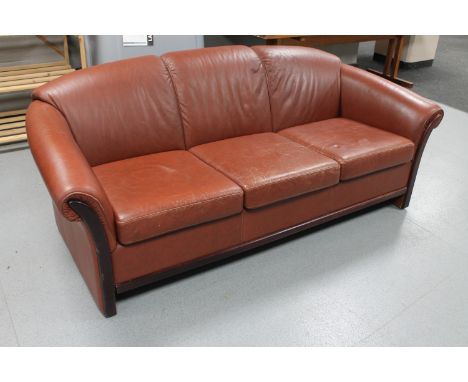 A late 20th century Danish brown leather three seater settee 