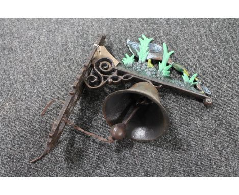 A cast iron duck wall bracket with bell