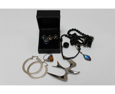 Two boxes of silver jewellery : charms, butterfly wing pendant on chain, silver and amber ring, jet ring and bracelet etc 