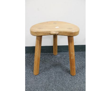 A Robert 'Mouseman' Thompson of Kilburn oak tripod stool, with carved mouse signature