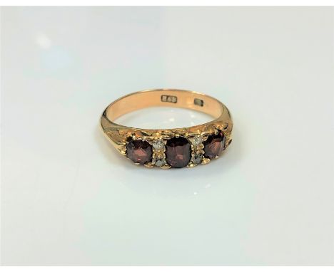 An 18ct gold diamond and garnet ring, size N CONDITION REPORT: 4.3g