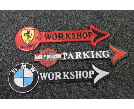 Three cast iron signs; BMW Workshop, Ferrari Workshop and Harley Davidson Motorcycles 