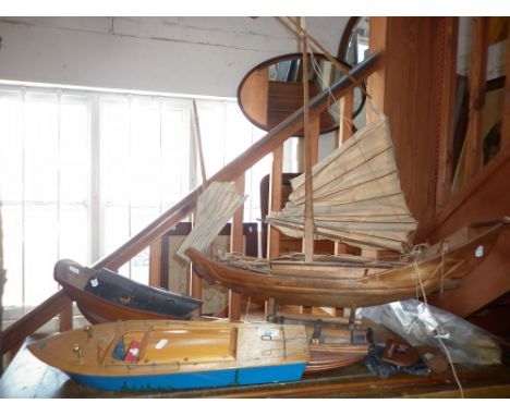 Scale wooden models of a Chinese sailing junk, a sampan and a wooden model of a Riva speedboat with electric motor